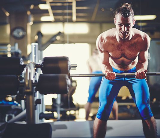 Fit sportsman lifting weight